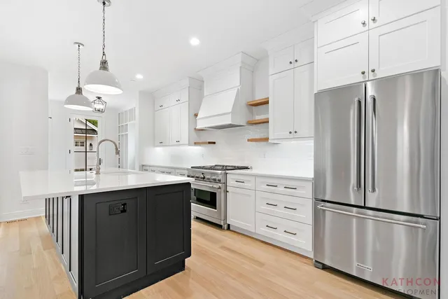 a kitchen with stainless steel appliances a refrigerator sink and cabinets