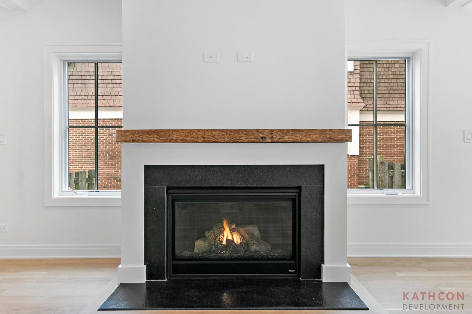 650 Sanders Road Northbrook, IL 60062 - Photo 20 of 24 a living room with a fireplace a lamp and a window