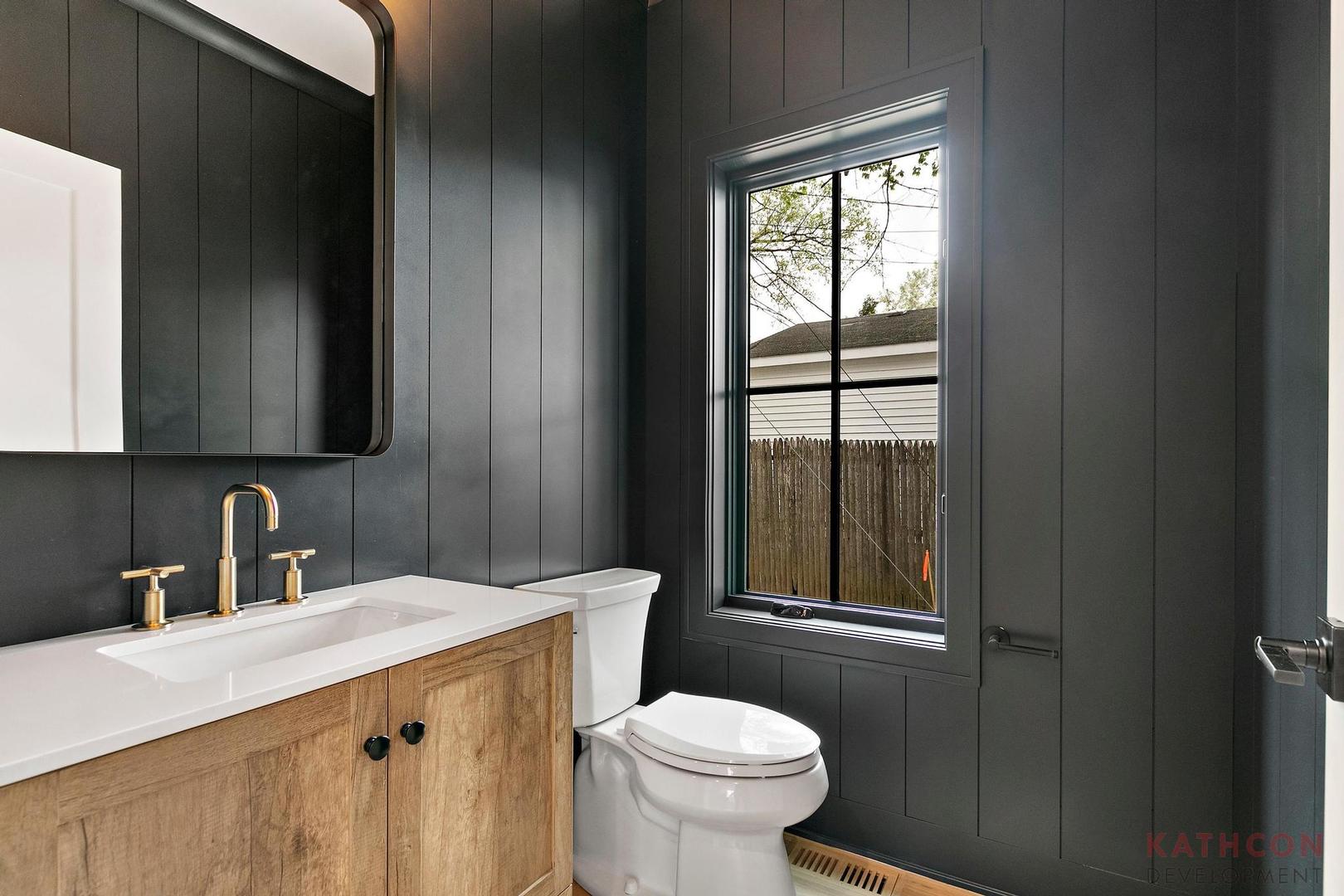 650 Sanders Road Northbrook, IL 60062 - Photo 22 of 24 a bathroom with a sink a toilet and a mirror