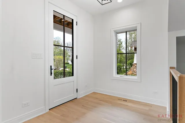 an empty room with windows and closet