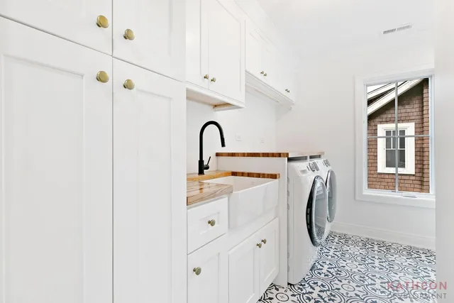 a close view of a sink and cabinets