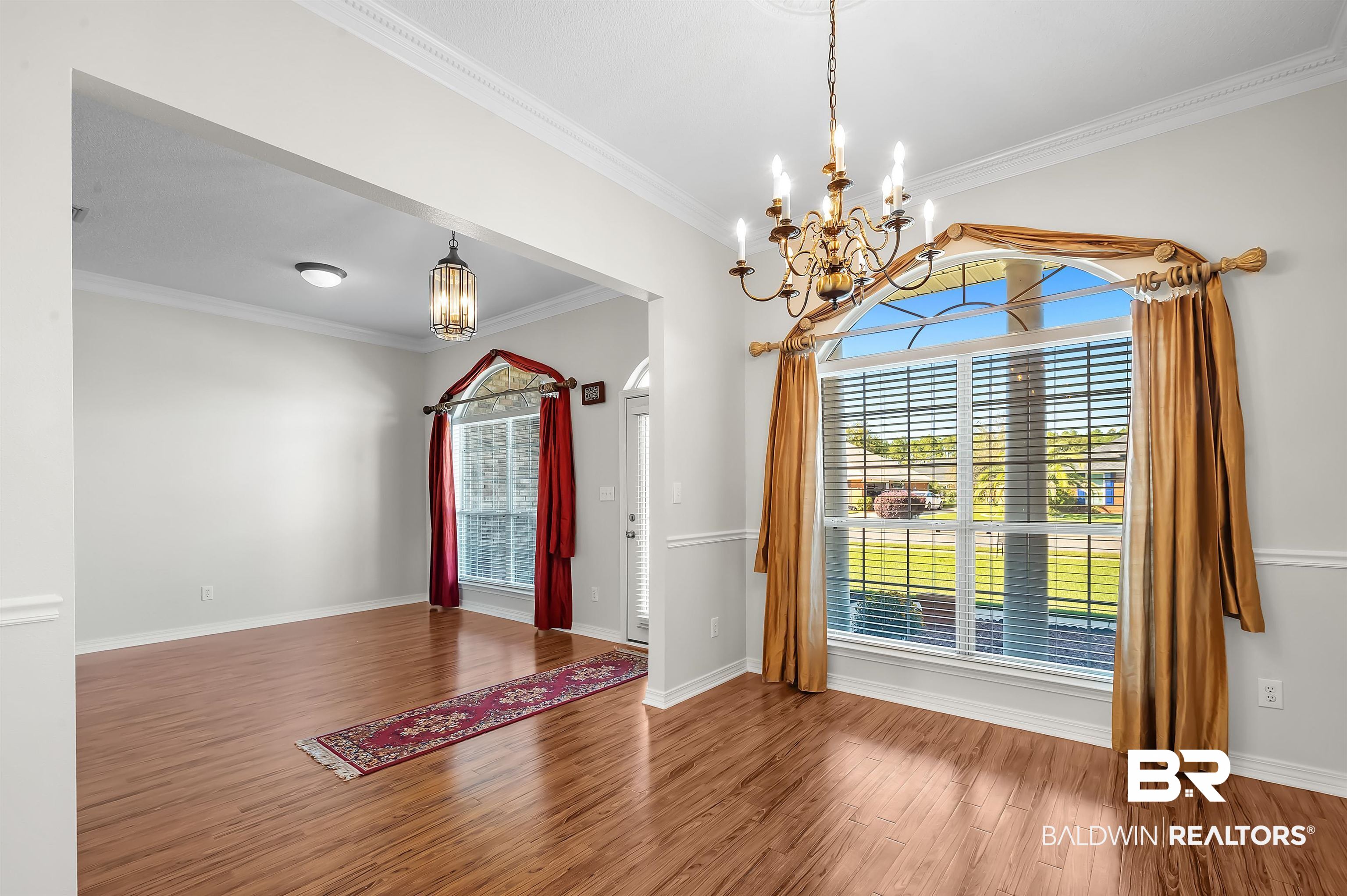 421 Collinwood Loop Foley, AL 36535 - Photo 24 of 62 Entryway featuring wood-type flooring, ornamental molding, and a chandelier