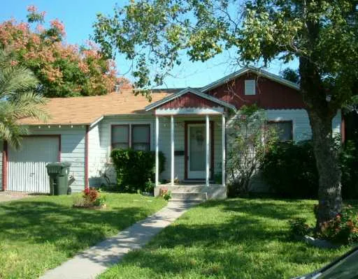 a front view of a house with a yard and porch