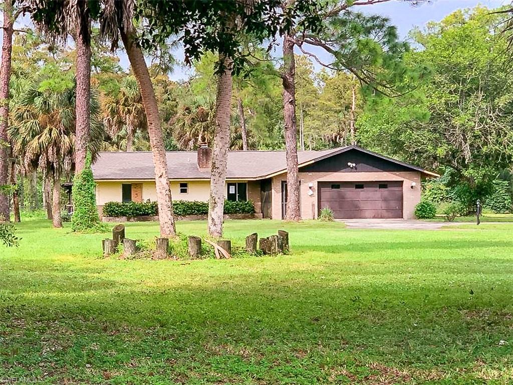 5975 Green Boulevard Naples, FL 34116 - Photo 1 of 20 a front view of a house with a yard