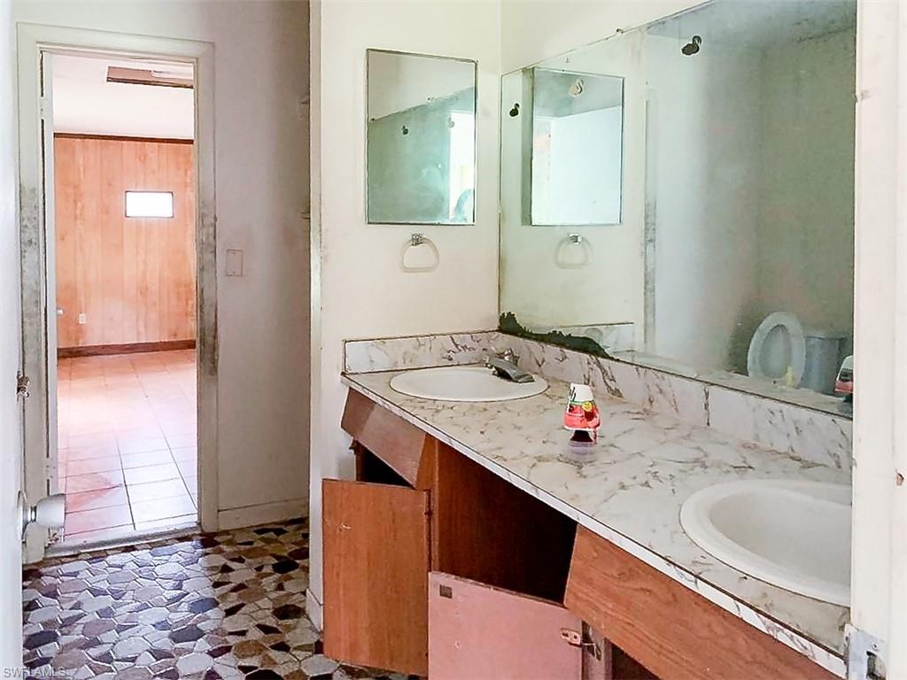 5975 Green Boulevard Naples, FL 34116 - Photo 13 of 20 a bathroom with a sink and a mirror