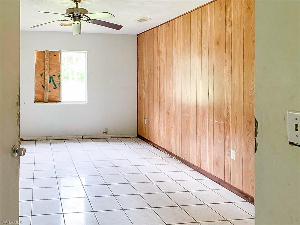5975 Green Boulevard Naples, FL 34116 - Photo 14 of 20 an empty room with windows and ceiling fan