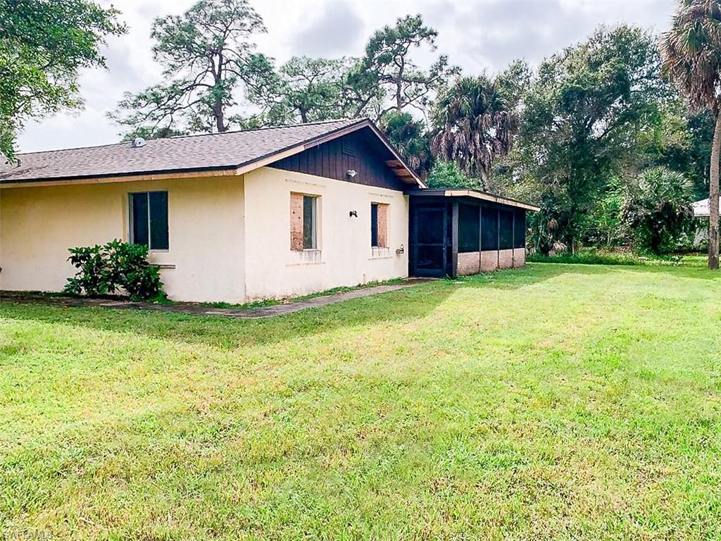 5975 Green Boulevard Naples, FL 34116 - Photo 18 of 20 a view of a backyard with plants and brick wall