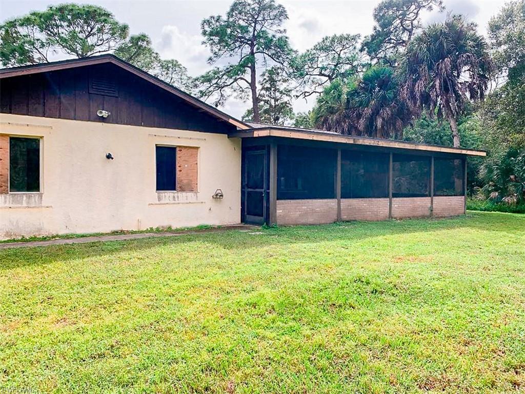 5975 Green Boulevard Naples, FL 34116 - Photo 19 of 20 a backyard of a house with lots of green space