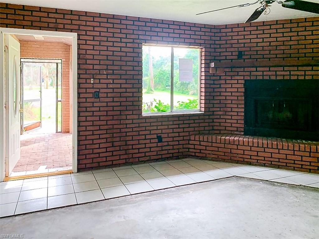 5975 Green Boulevard Naples, FL 34116 - Photo 3 of 20 a view of a brick wall of the house