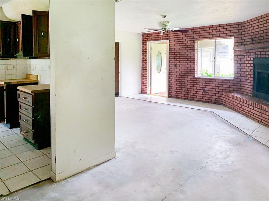 5975 Green Boulevard Naples, FL 34116 - Photo 6 of 20 a view of an empty room with window and cabinet