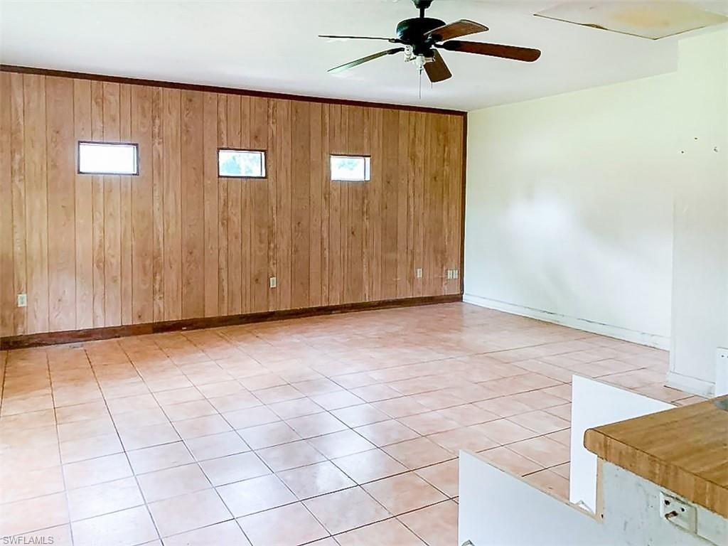 5975 Green Boulevard Naples, FL 34116 - Photo 10 of 20 a view of a livingroom with a ceiling fan and wooden floor