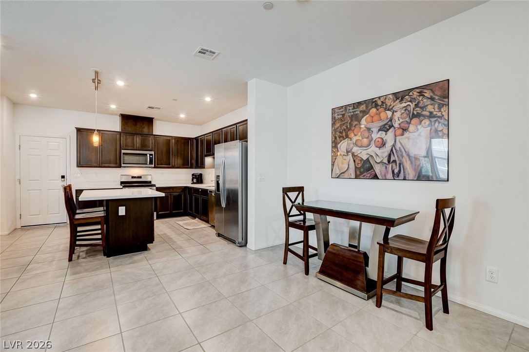 484 Filaree Place Henderson, NV 89015 - Photo 8 of 71 This spacious kitchen offers ample storage and a convenient breakfast bar, perfect for casual dining.