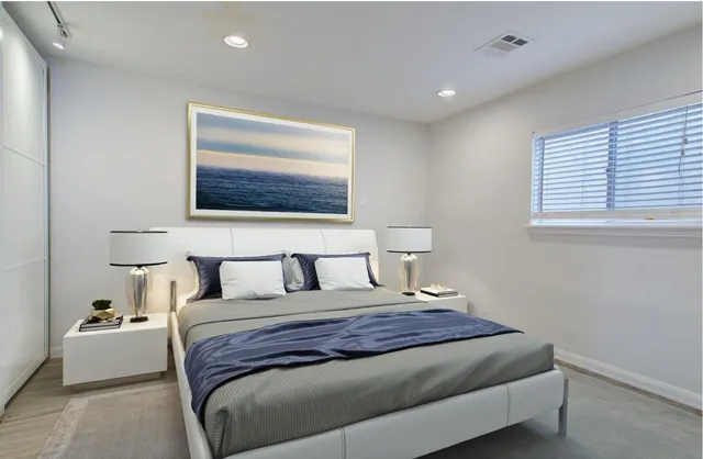 a bedroom with a large bed and a window