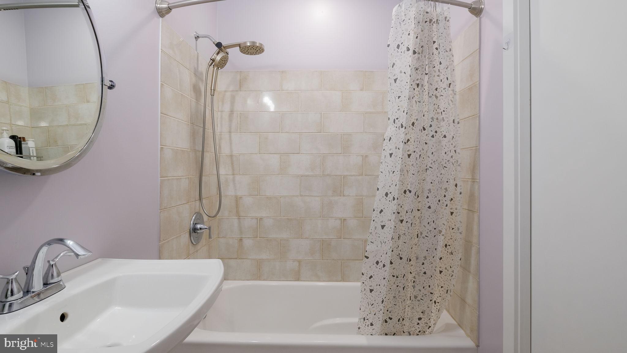 2308 3rd Marcus Hook, PA 19061 - Photo 22 of 37 a bathroom with a shower a mirror and a sink