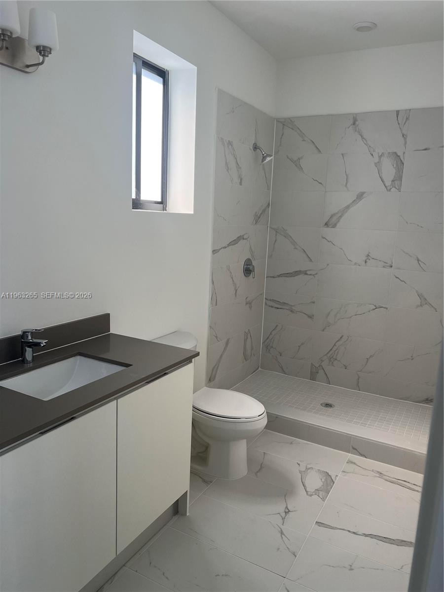 34531 Southwest 191st Avenue Homestead, FL 33030 - Photo 14 of 20 a bathroom with a granite countertop sink a toilet and shower