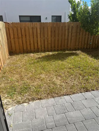 a view of a house with a wooden fence