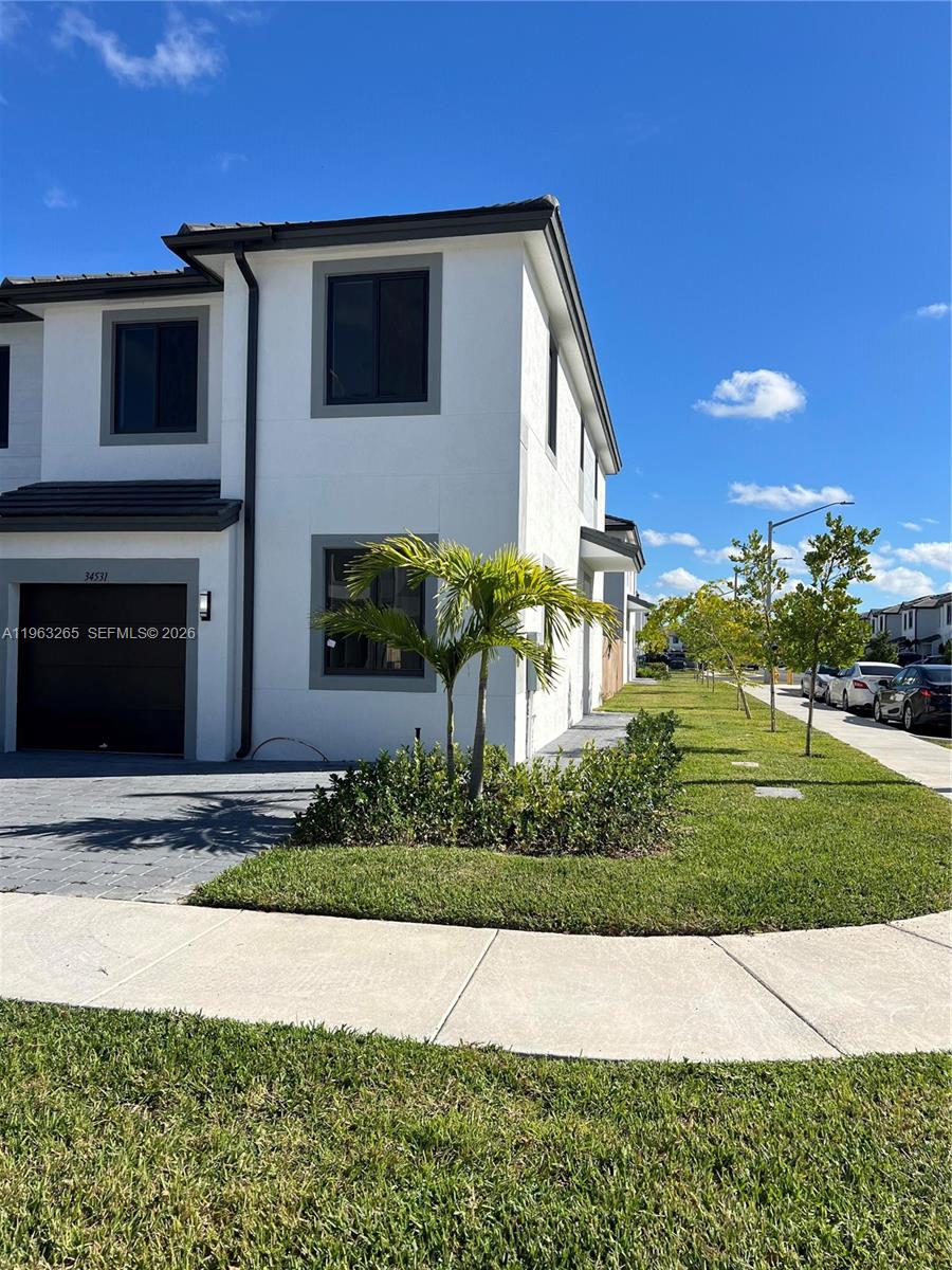 34531 Southwest 191st Avenue Homestead, FL 33030 - Photo 19 of 20 a front view of a house with a yard