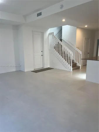 a view of an empty room with windows