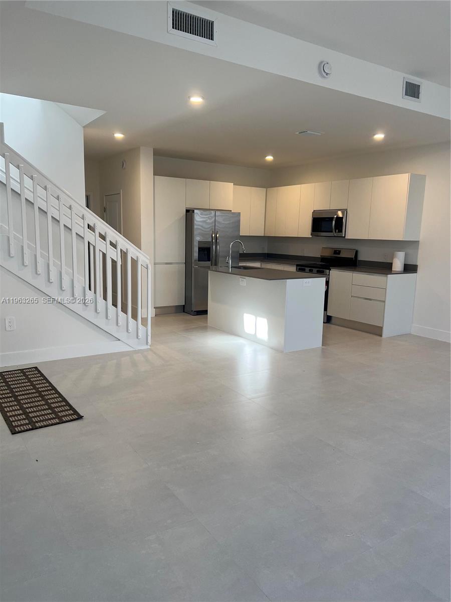 34531 Southwest 191st Avenue Homestead, FL 33030 - Photo 3 of 20 a view of kitchen with kitchen island stainless steel appliances refrigerator stove microwave and stove