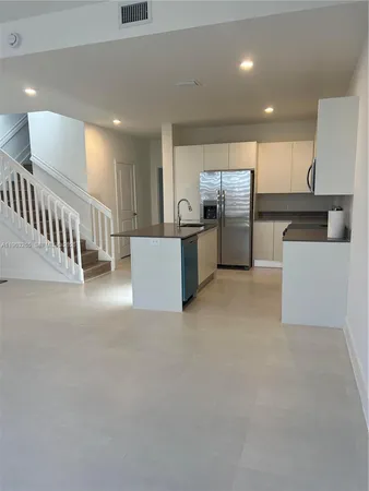 a view of kitchen with furniture and windows