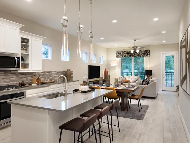 a dining room with stainless steel appliances kitchen island granite countertop a sink a stove a dining table and chairs