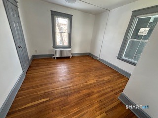 14 Guilfoile Street, Unit 2 Waterbury, CT 06708 - Photo 11 of 17 a view of an empty room with wooden floor and a window