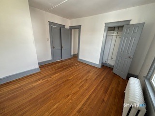 14 Guilfoile Street, Unit 2 Waterbury, CT 06708 - Photo 12 of 17 a view of an empty room with wooden floor and a window