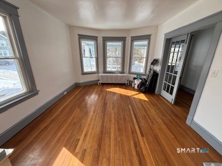 14 Guilfoile Street, Unit 2 Waterbury, CT 06708 - Photo 2 of 17 a view of a livingroom with wooden floor and staircase