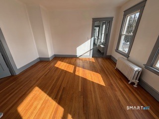 14 Guilfoile Street, Unit 2 Waterbury, CT 06708 - Photo 3 of 17 a view of an empty room with wooden floor