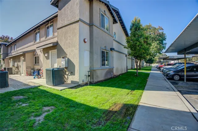 a front view of a house with a garden and houses