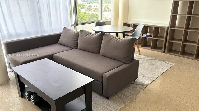 a living room with furniture and a window