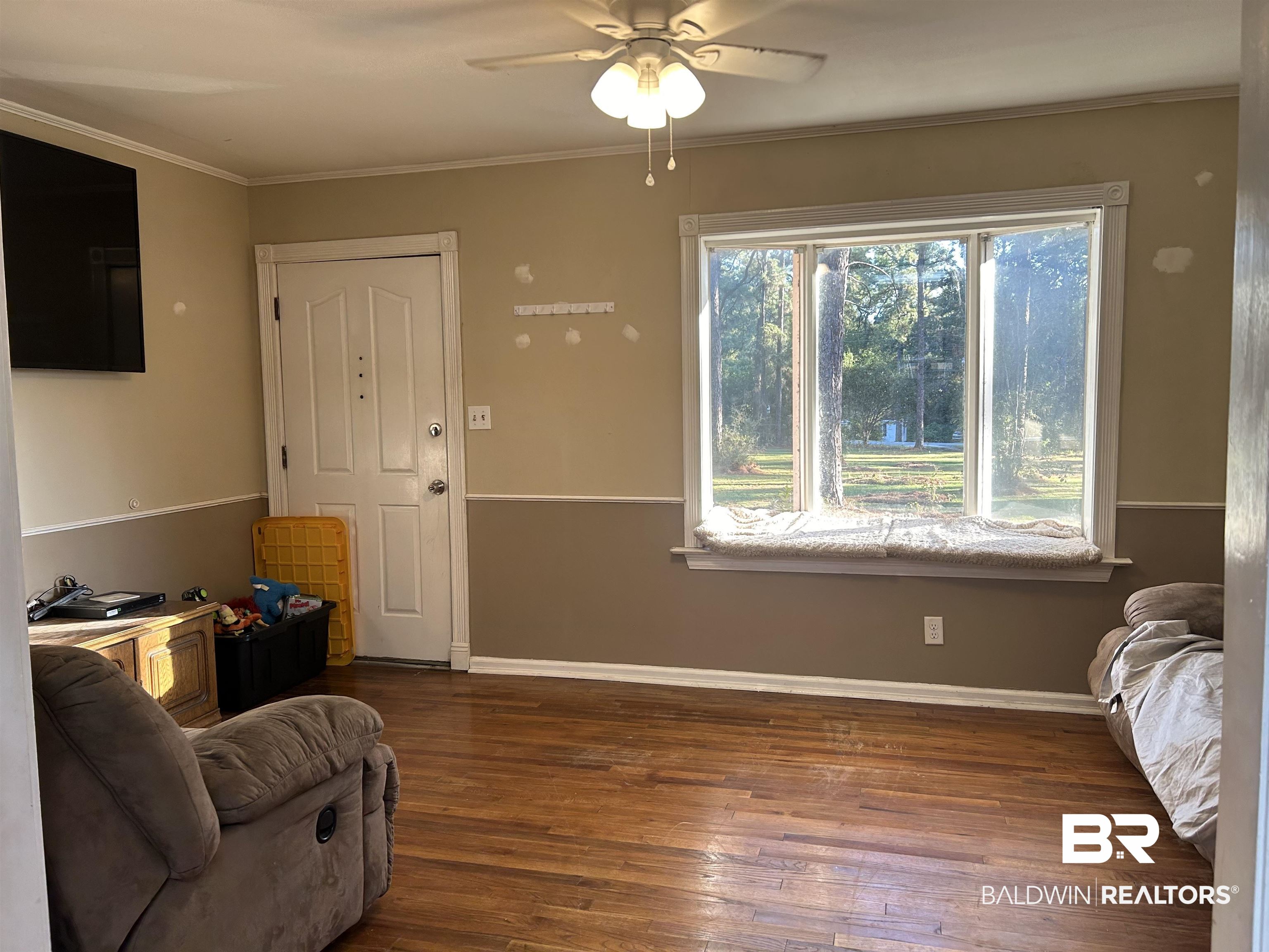 32140 Buzbee Road Daphne, AL 36527 - Photo 4 of 10 Living room with ceiling fan, wood-type flooring, and ornamental molding