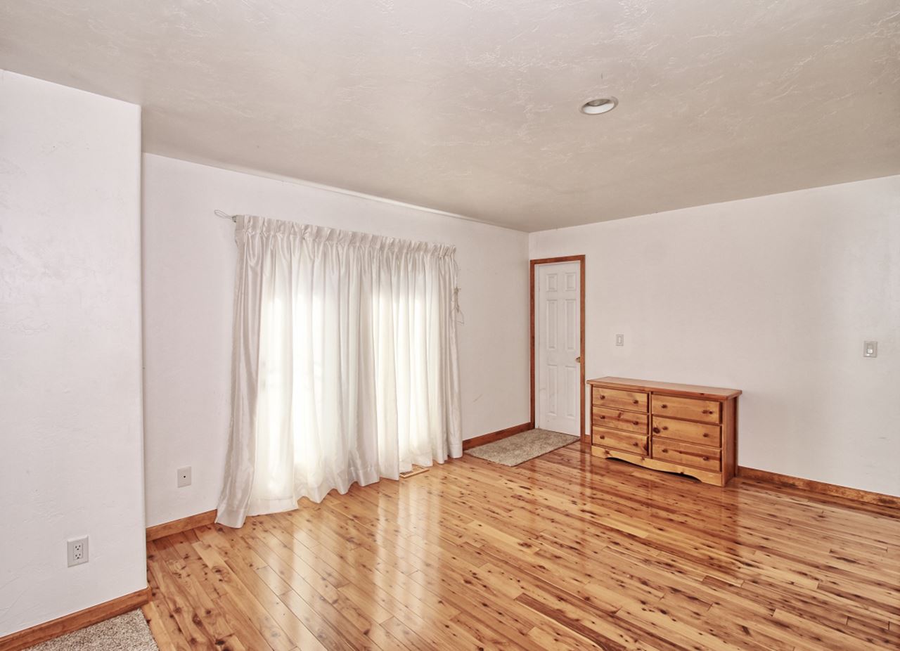 1066-19 19 1/2 Road Fruita, CO 81521 - Photo 15 of 42 a view of a room with wooden floor and window