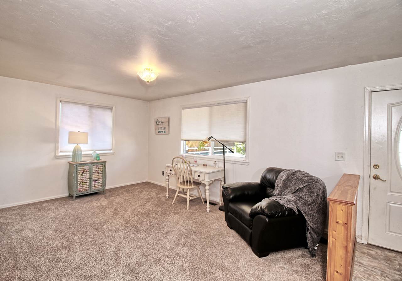 1066-19 19 1/2 Road Fruita, CO 81521 - Photo 3 of 42 a living room with furniture a window and a table