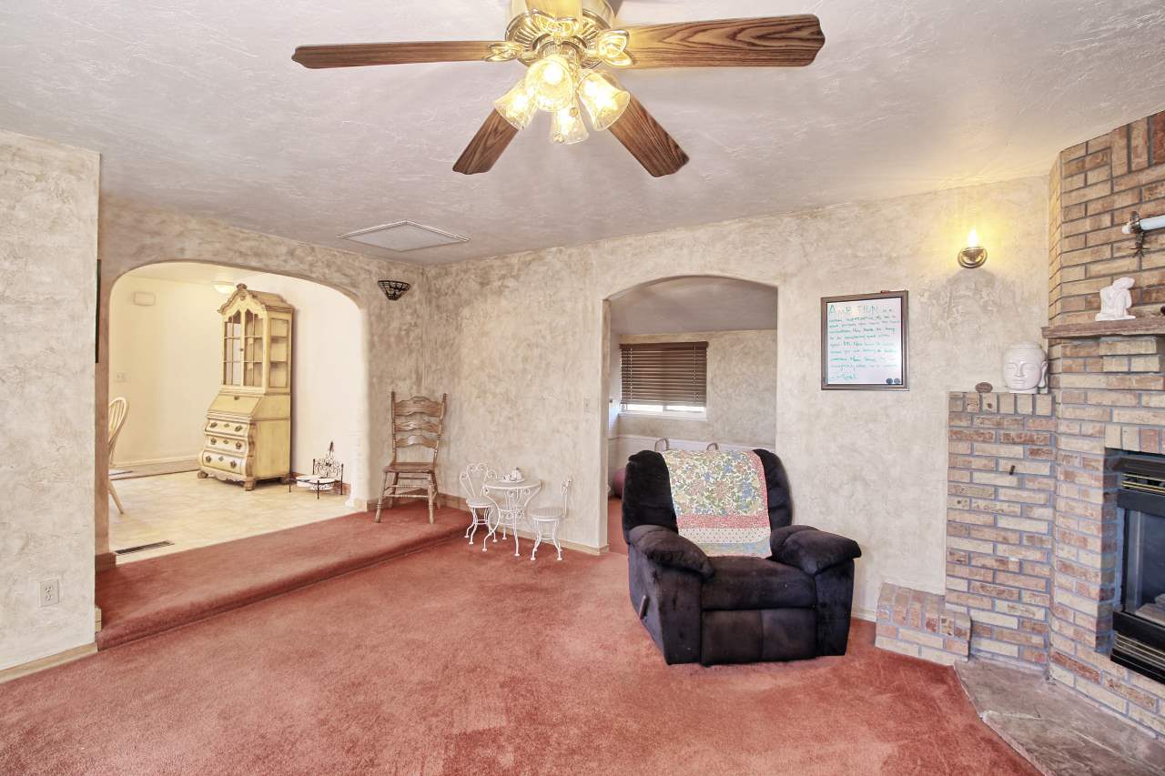 1066-19 19 1/2 Road Fruita, CO 81521 - Photo 32 of 42 a living room with furniture and a fireplace