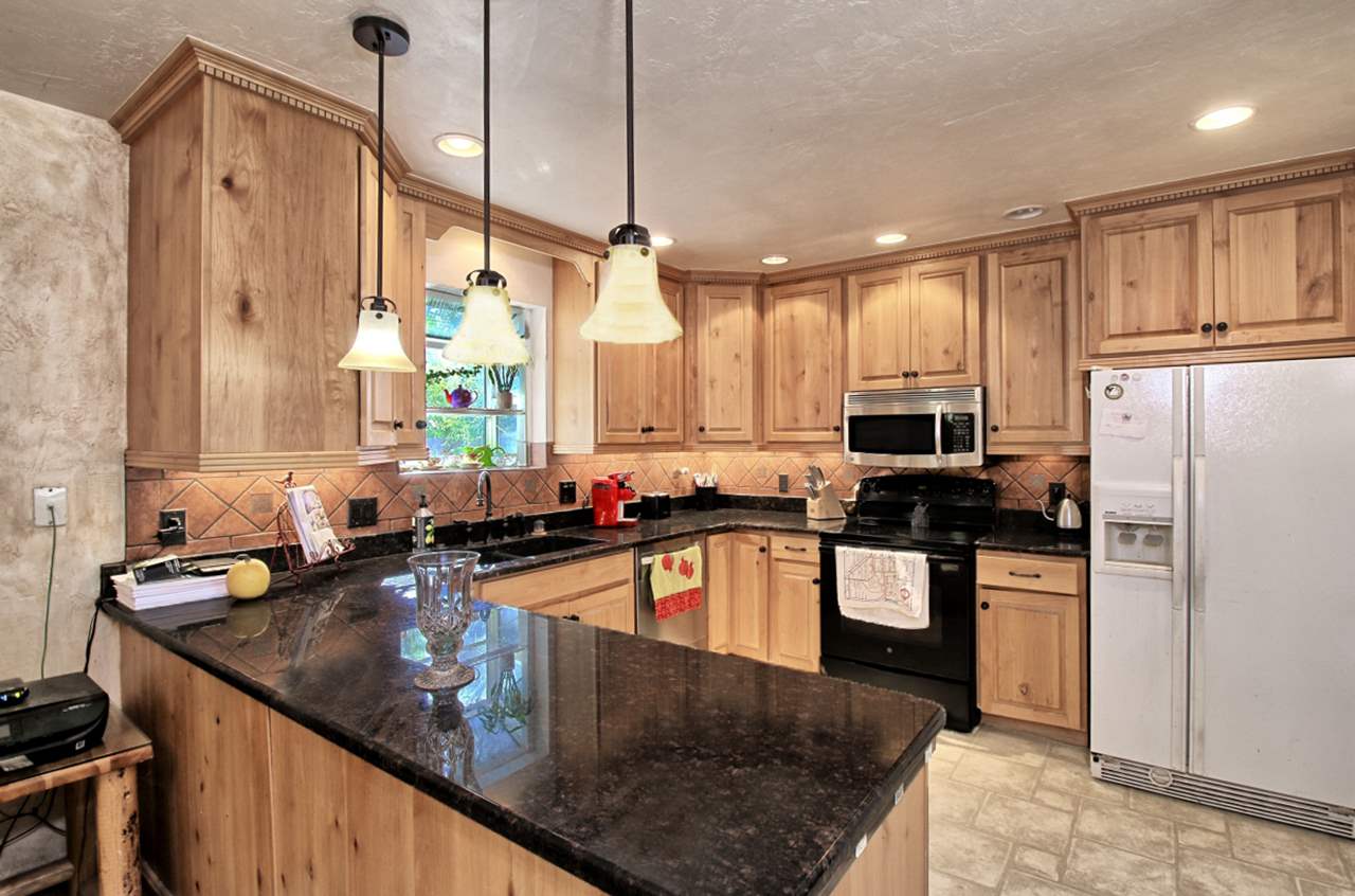 1066-19 19 1/2 Road Fruita, CO 81521 - Photo 7 of 42 a kitchen with stainless steel appliances granite countertop a sink a stove and refrigerator