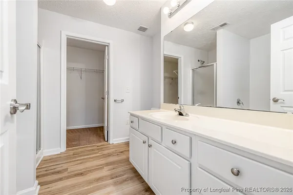 a spacious bathroom with a sink and a mirror
