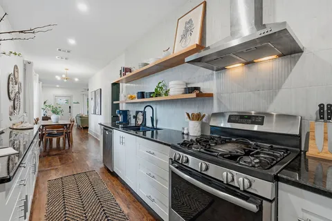 a kitchen with a stove and cabinets