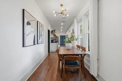 a view of a dining room with furniture and wooden floor