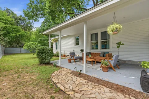 a backyard of a house with outdoor seating