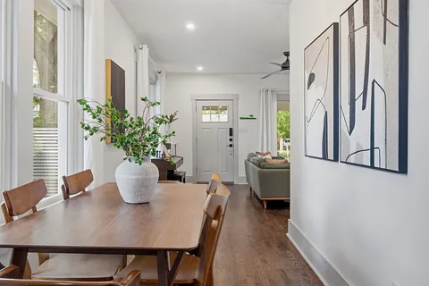 a view of a dining room with furniture and wooden floor