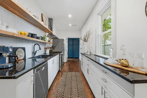 a kitchen with granite countertop lots of counter space and a sink