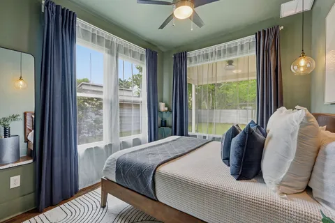 a bedroom with a bed and glass window
