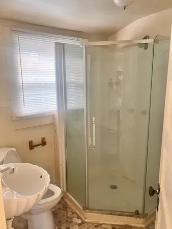 a bathroom with a shower and a toilet