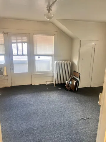 a view of a livingroom with furniture and staircase
