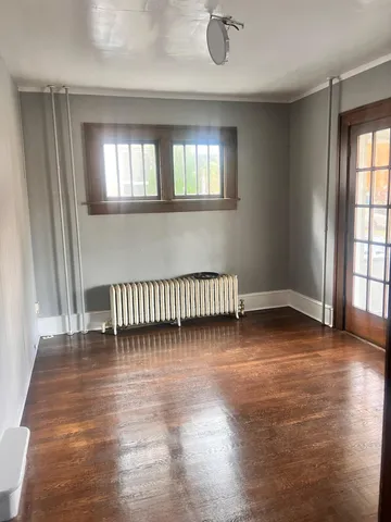 wooden floor in a hall with a window