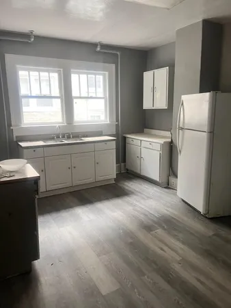 a kitchen with a refrigerator and a sink