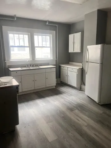 a kitchen with a refrigerator and a sink