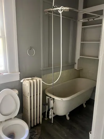 a bathroom with a toilet and a shower