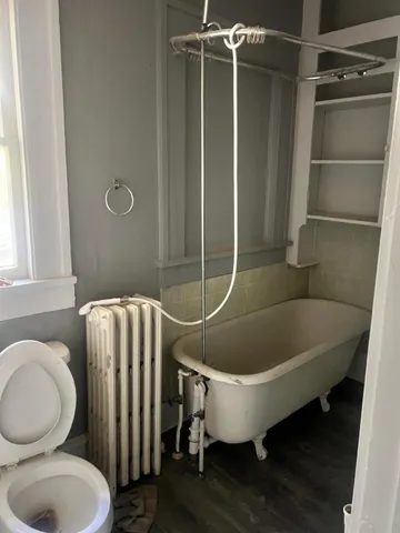 a bathroom with a toilet and a shower